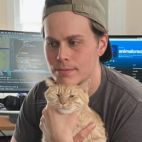 A picture of ryan holding his cat.